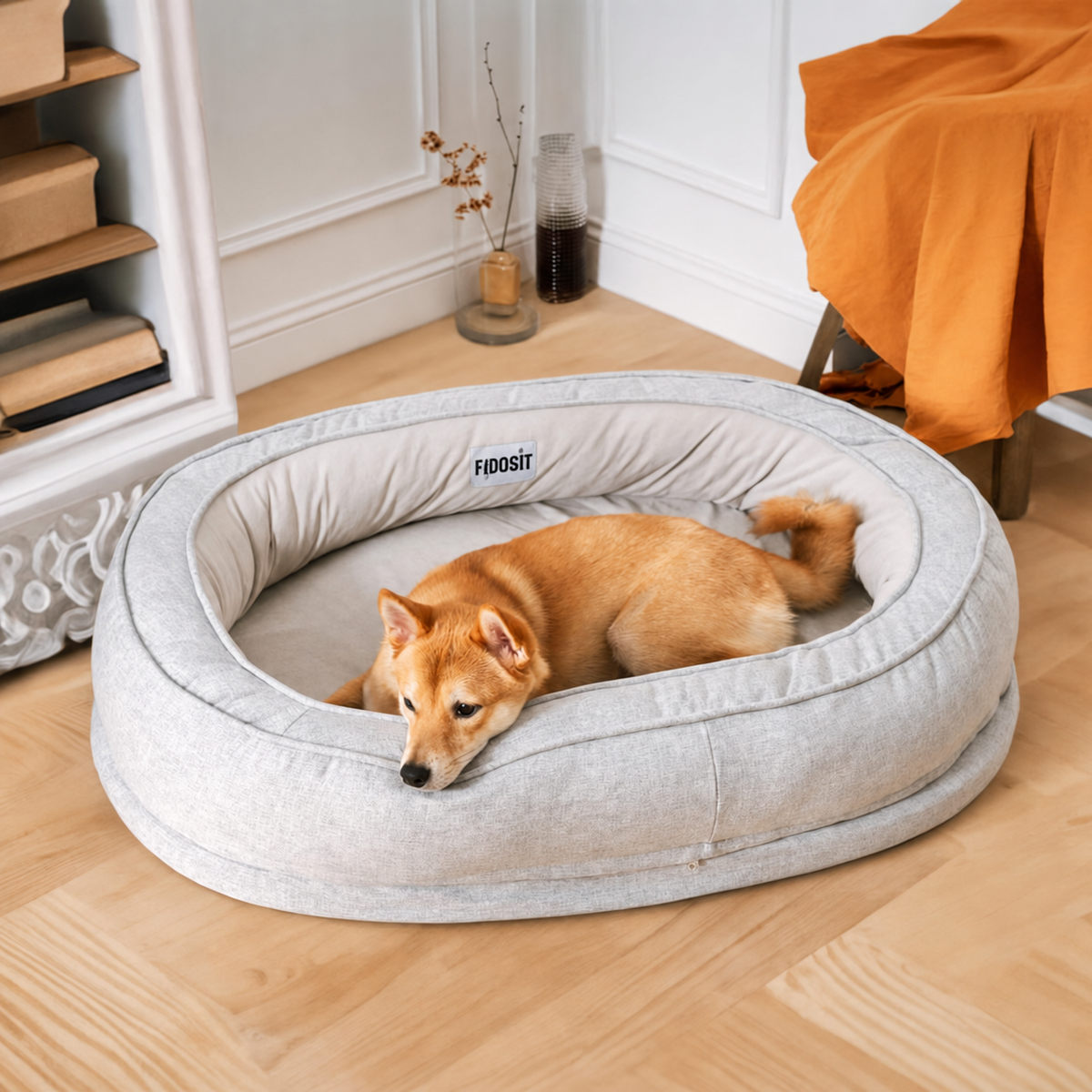 A dog resting in the Grey bed