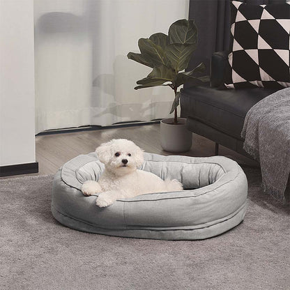 A small dog in the Grey Donut Dog Bed